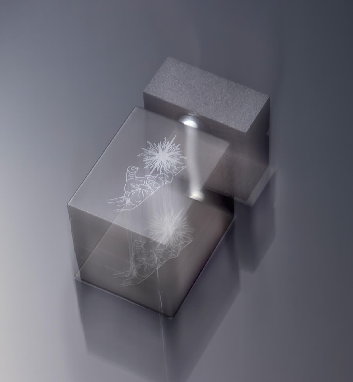 A bottle of Absent Presence Eau De Parfum floating with reflective light