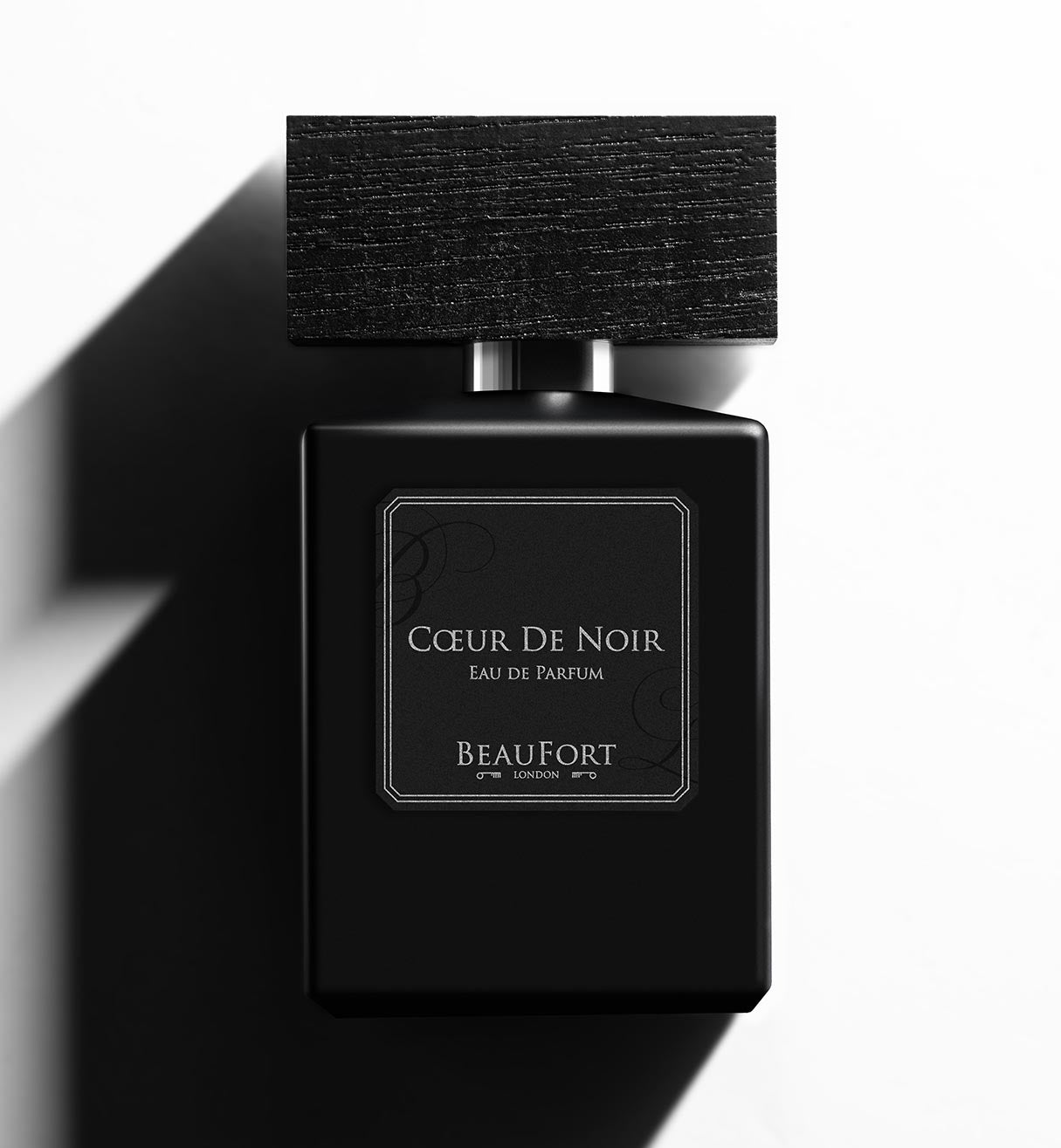 A bottle of BeauFort London's Coeur De Noir Eau De Parfum, on a white background with heavy shadow